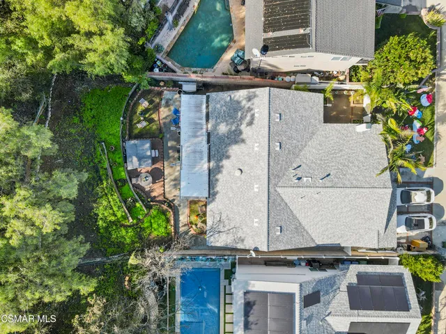 an aerial view of residential house with an outdoor space and mountain view