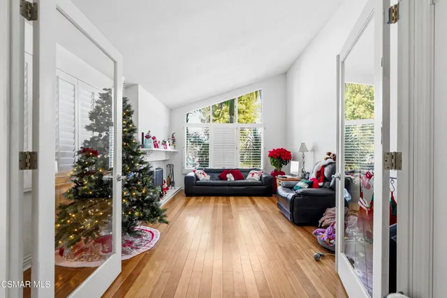 a living room with furniture and a christmas tree