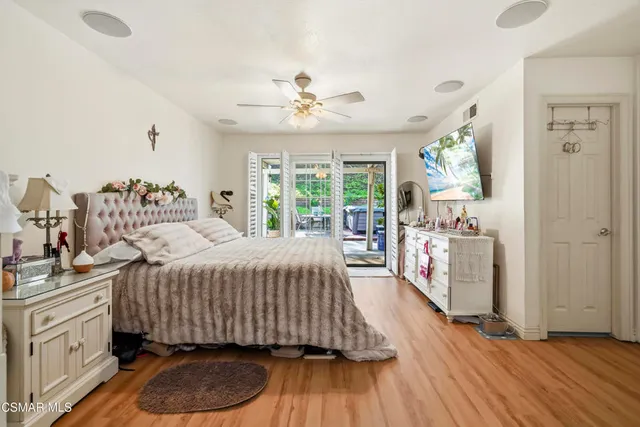 a bedroom with a bed and ceiling fan