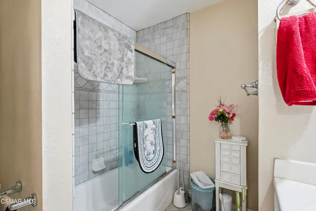 a bedroom with a bed and a chair