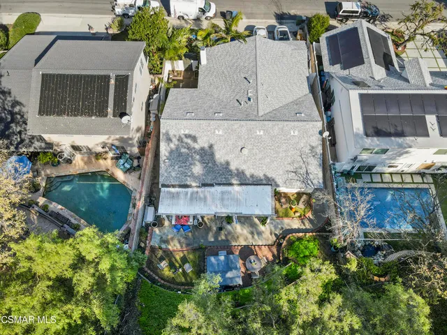 an aerial view of a house with a yard and lake view