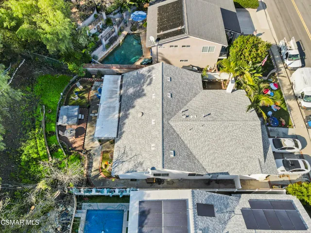an aerial view of a residential houses with outdoor space