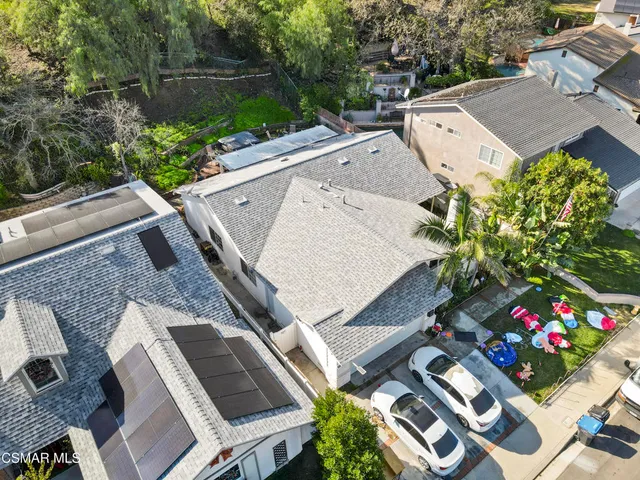 an aerial view of a house with a yard