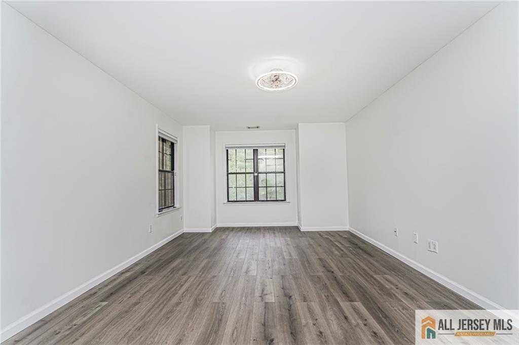 612 Chester Court Helmetta, NJ 08828 - Photo 16 of 31 an empty room with wooden floor and windows