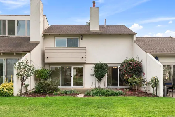 a view of a house with a yard and plants