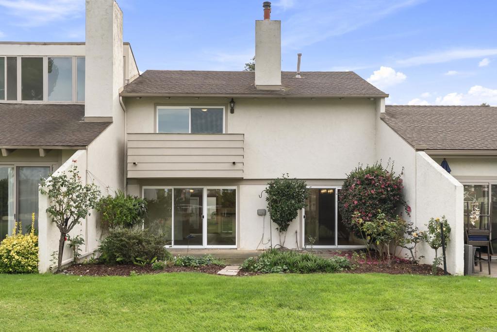 a view of a house with a yard and plants