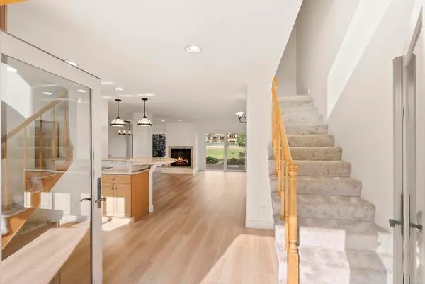 a view of a living room with furniture and wooden floor