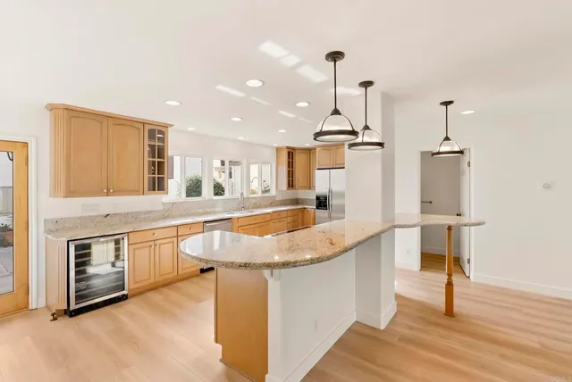 a view of a kitchen with a sink and a large window