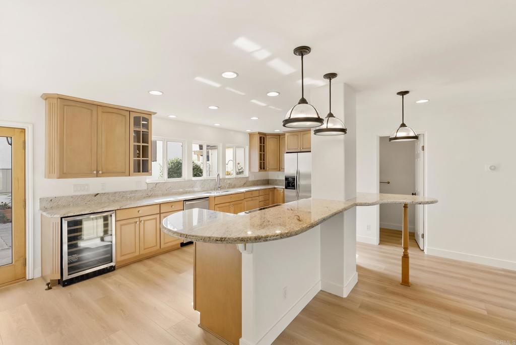 219 Via Osuna Rancho Santa Fe, CA 92091 - Photo 14 of 50 a kitchen with stainless steel appliances granite countertop a sink a stove and a wooden floor