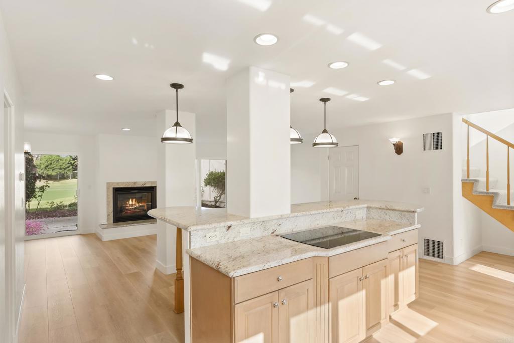 219 Via Osuna Rancho Santa Fe, CA 92091 - Photo 16 of 50 a kitchen with a sink chandelier and wooden floor