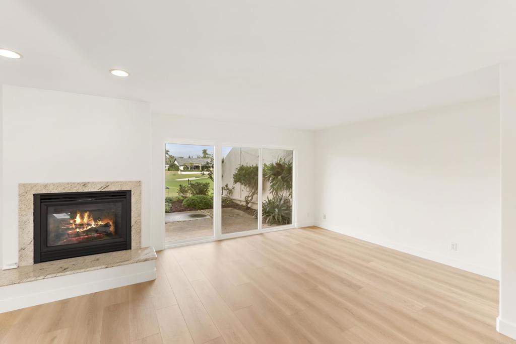 219 Via Osuna Rancho Santa Fe, CA 92091 - Photo 18 of 50 a view of an empty room with wooden floor fireplace and a window
