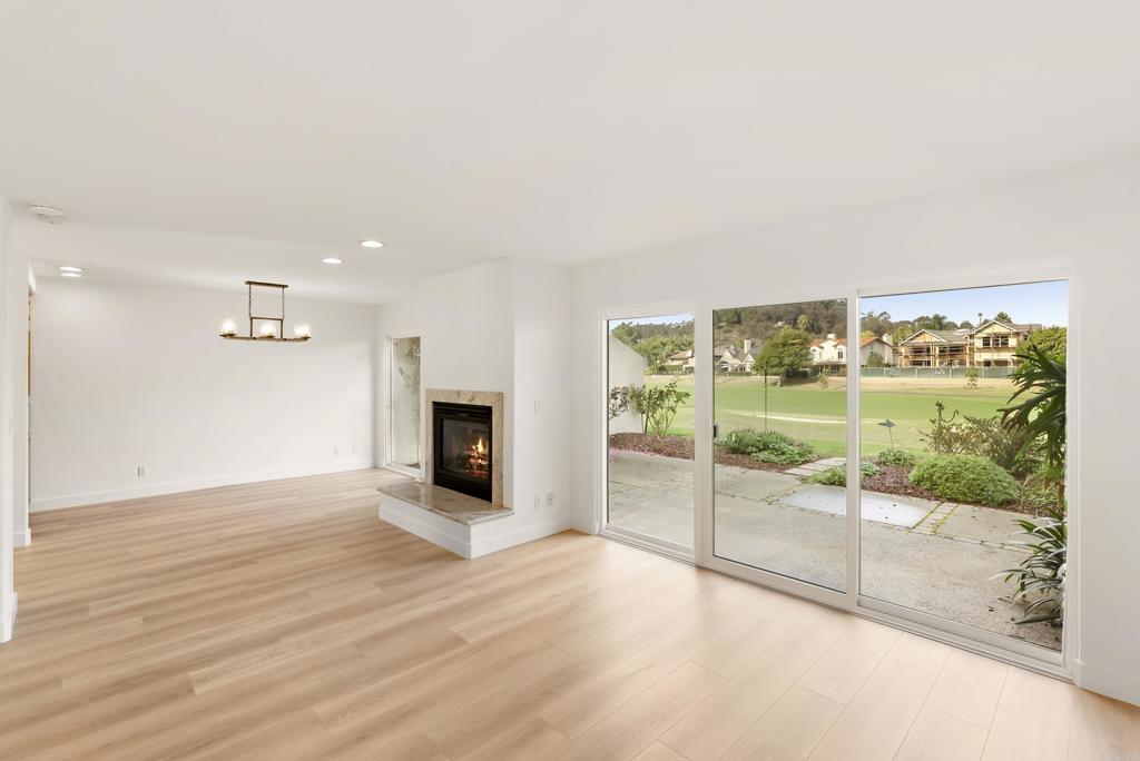 219 Via Osuna Rancho Santa Fe, CA 92091 - Photo 19 of 50 an empty room with wooden floor and fireplace