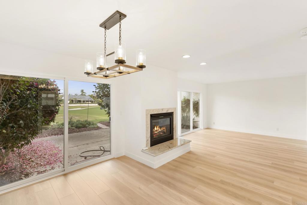 219 Via Osuna Rancho Santa Fe, CA 92091 - Photo 23 of 50 a view of a livingroom with a fireplace wooden floor and chandelier