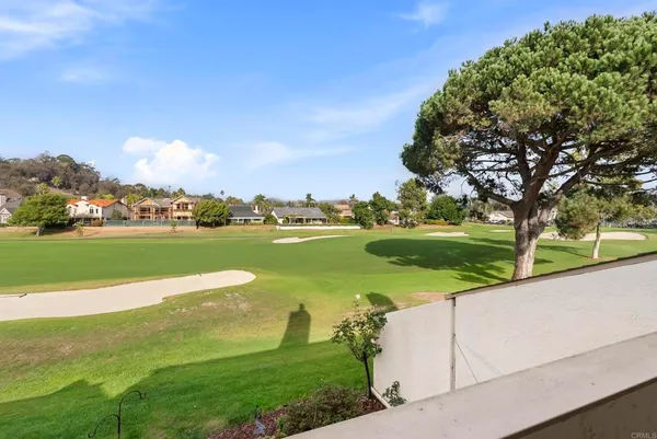 a bathroom with a granite countertop sink a mirror and a shower