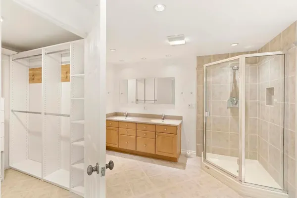 a view of walk in closet with empty racks