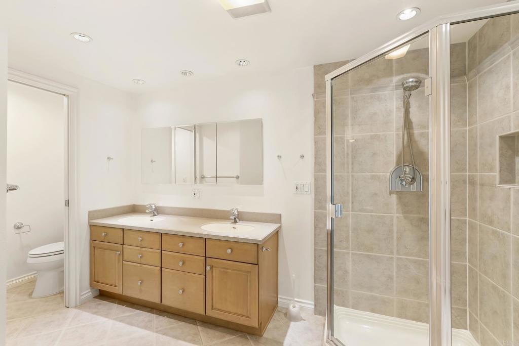 219 Via Osuna Rancho Santa Fe, CA 92091 - Photo 31 of 50 a spacious bathroom with a shower sink and mirror