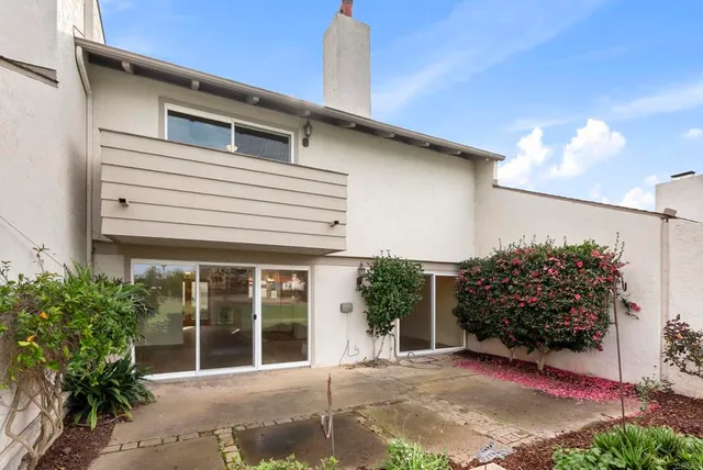 a view of an ocean with a big yard and large trees