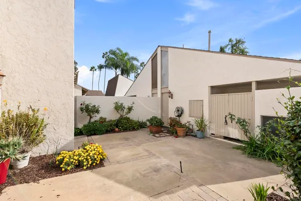 a front view of a house with lots of potted plants
