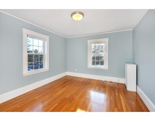 39 Upland Road Arlington, MA 02474 - Photo 25 of 30 a view of an empty room with wooden floor and a window