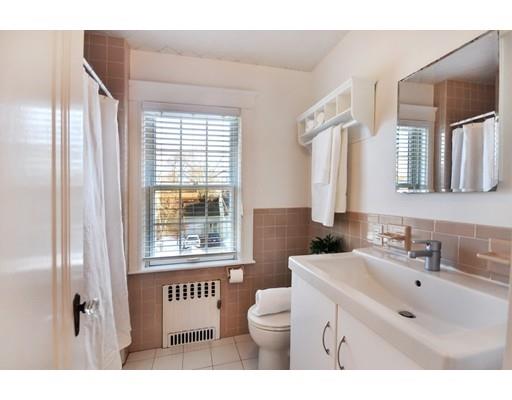 39 Upland Road Arlington, MA 02474 - Photo 28 of 30 a bathroom with a sink a toilet and a mirror