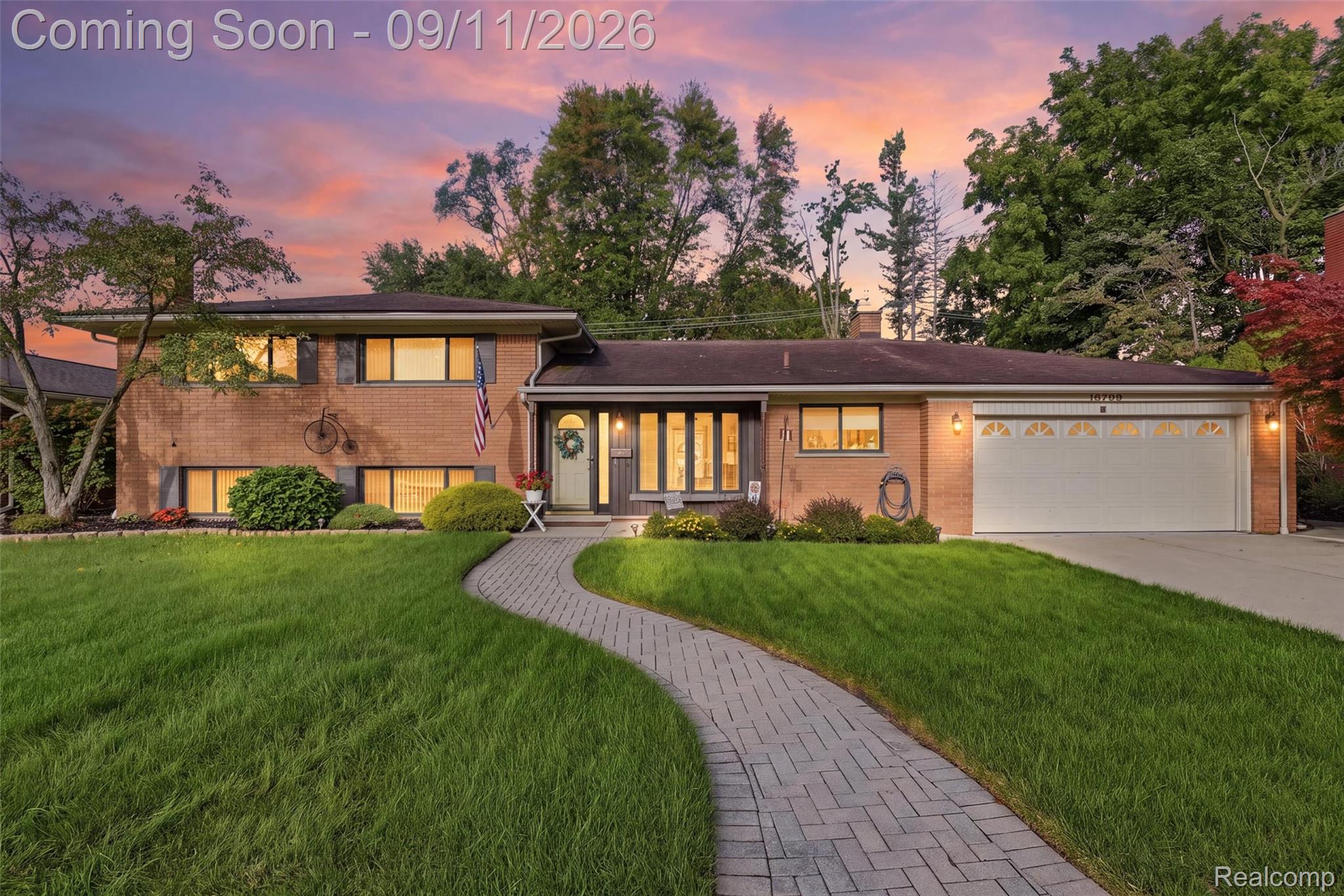 16799 Farmington Road Livonia, MI 48154 - Photo 1 of 71 Brick exterior featuring multiple windows, a two-car garage, and a paver walkway