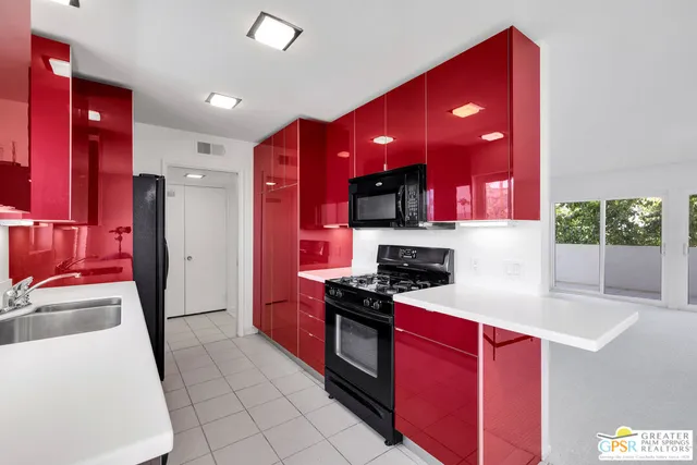 a kitchen with a sink a stove and a refrigerator