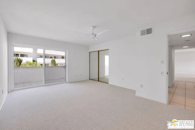 an empty room with windows and closet