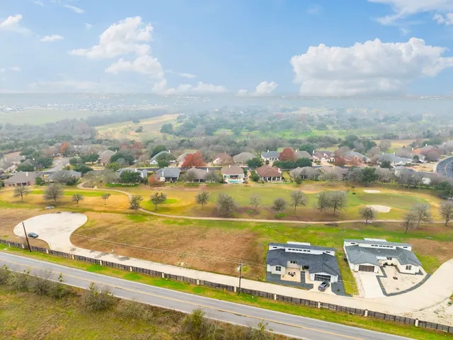 an aerial view of a city with a lake view