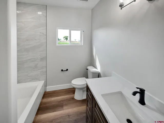 a bathroom with a sink a toilet and a bathtub