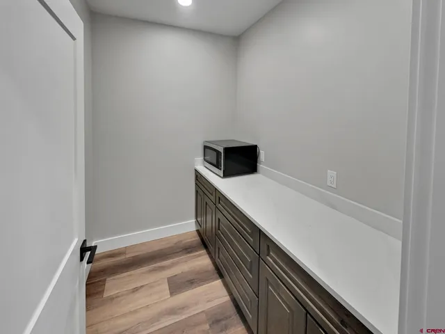 a view of a room with wooden floor and stairs