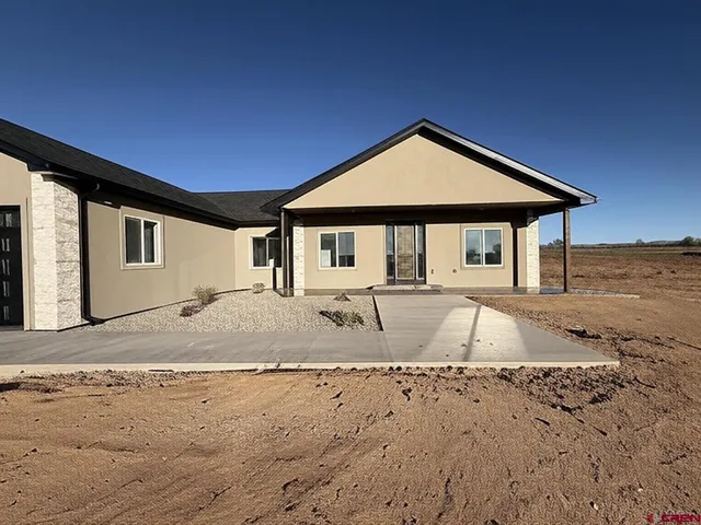 a view of a house with snow on the road