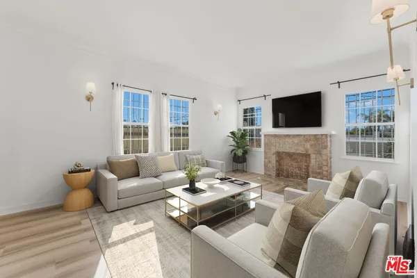 a living room with furniture a fireplace and a flat screen tv