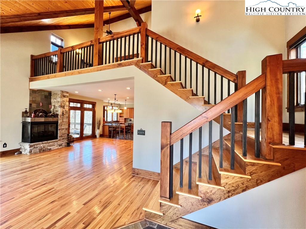 259 The Settlement Boone, NC 28607 - Photo 13 of 50 a view of staircase with lots of frames on wall and wooden floor