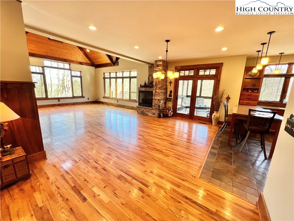 259 The Settlement Boone, NC 28607 - Photo 22 of 50 a view of a living room and kitchen with furniture wooden floor and windows