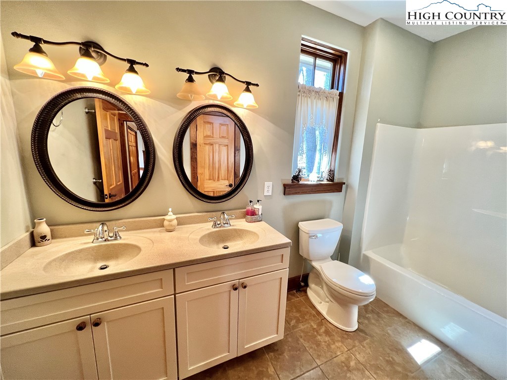 259 The Settlement Boone, NC 28607 - Photo 25 of 50 a bathroom with 2 sink and a mirror