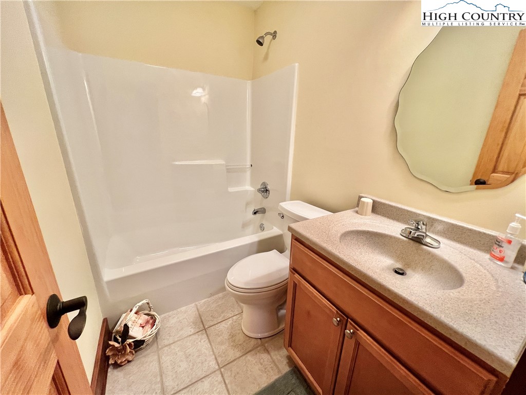 259 The Settlement Boone, NC 28607 - Photo 36 of 50 a bathroom with a sink and mirror with toilet