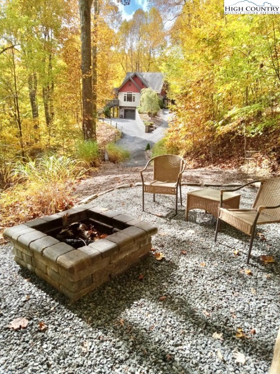 259 The Settlement Boone, NC 28607 - Photo 50 of 50 a view of swimming pool with lawn chairs and wooden fence