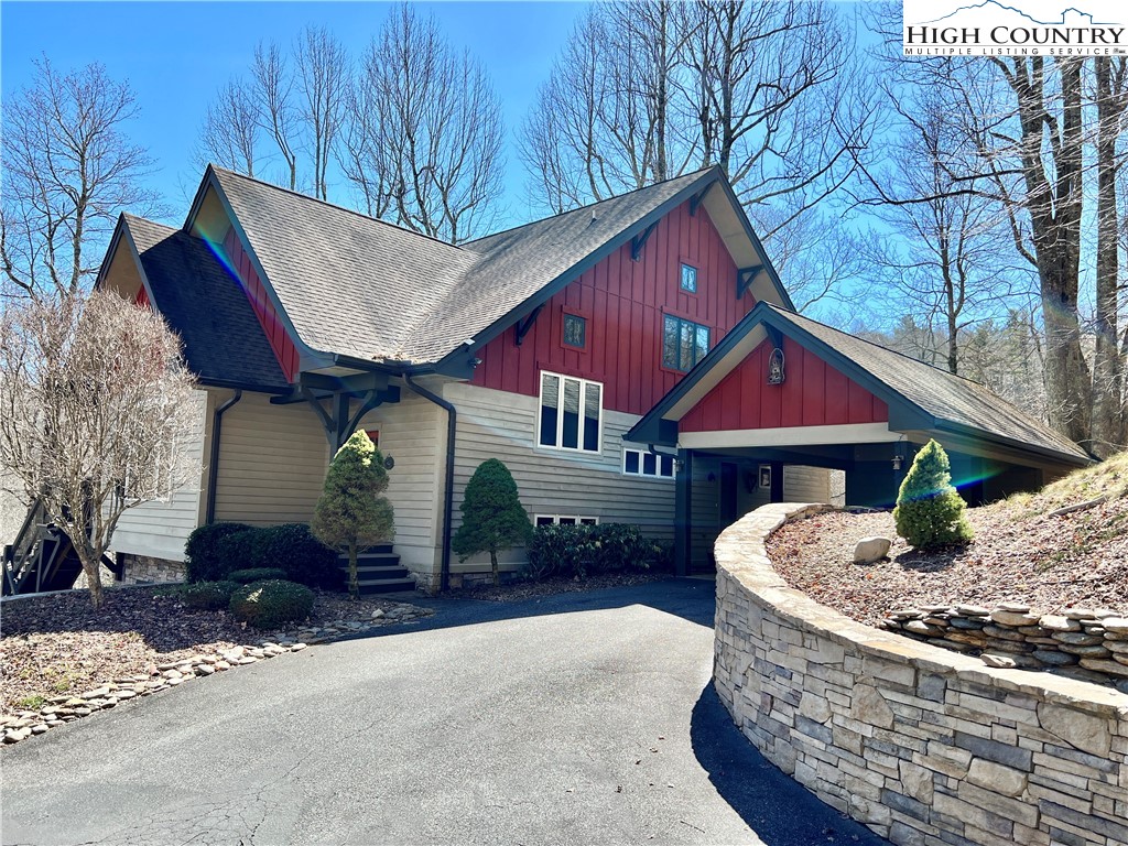 259 The Settlement Boone, NC 28607 - Photo 5 of 50 a front view of a house with a yard and garage