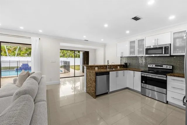 a large kitchen with stainless steel appliances lots of counter top space