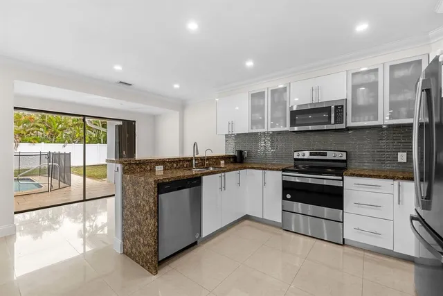 a kitchen with stainless steel appliances granite countertop a stove and a sink