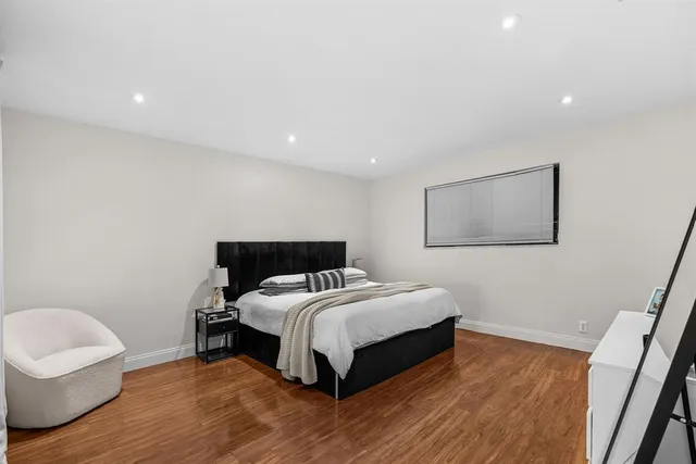 a bedroom with a bed and a chair