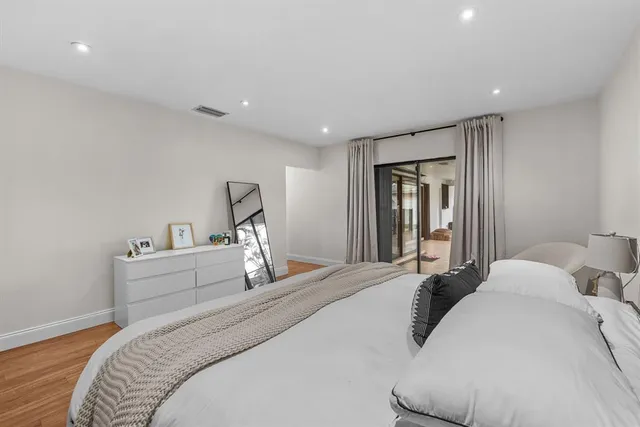 a bedroom with a large bed and a chandelier