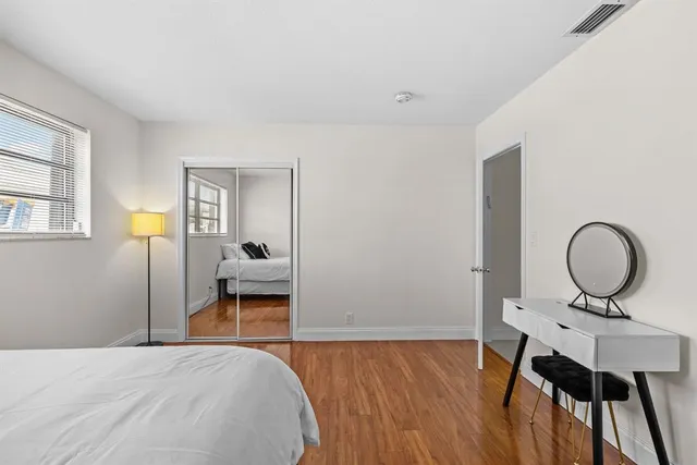 a bathroom with a sink a toilet a mirror and shower