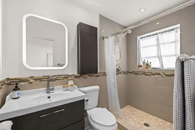 a bedroom with two beds and painting on the wall