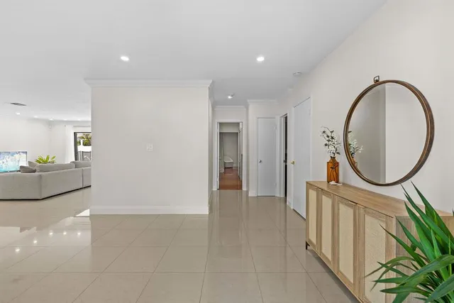 a view of a hallway with wooden floor and furniture