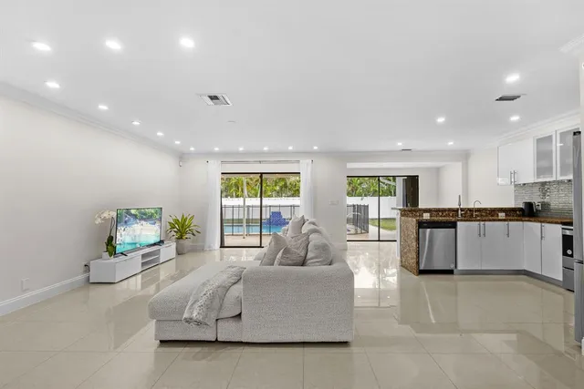 a living room with kitchen island furniture and a large window