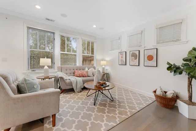a living room with furniture and floor to ceiling windows