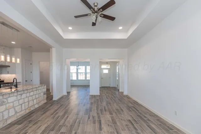 a kitchen with granite countertop a sink stove and refrigerator