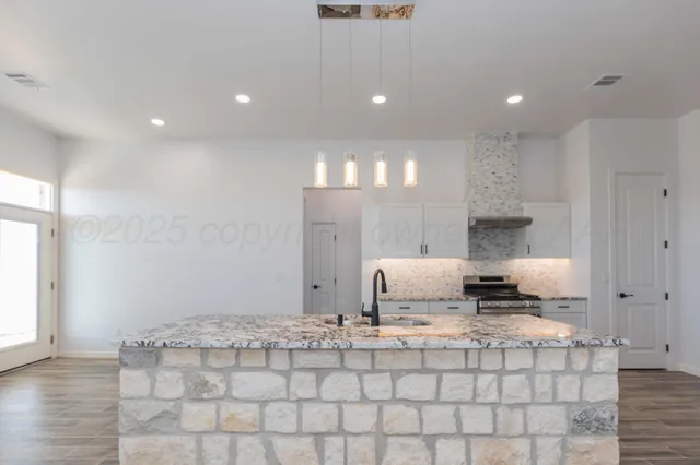 a stove top oven sitting inside of a kitchen