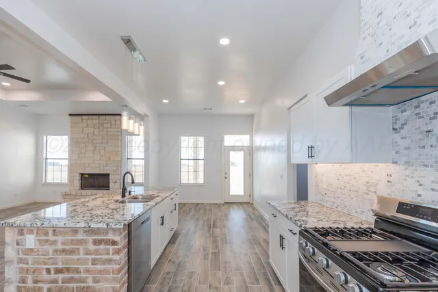 a spacious bathroom with a granite countertop sink and a mirror